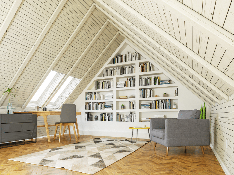 Home office with a backwall shelf filled with books.