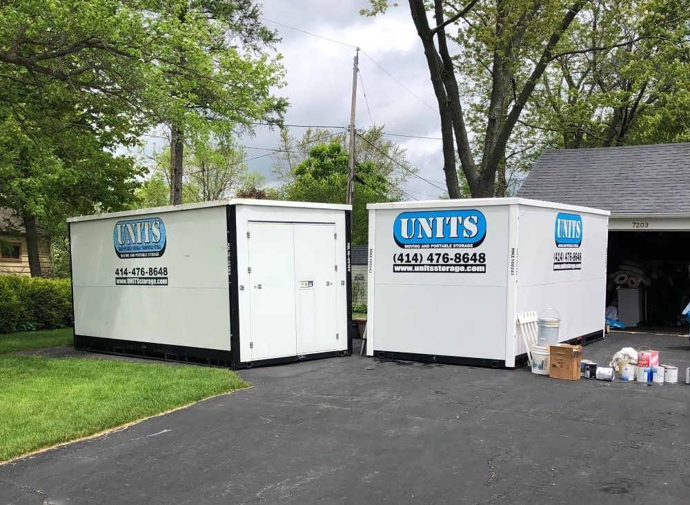 Two UNITS Moving and Portable Storage containers in a driveway.