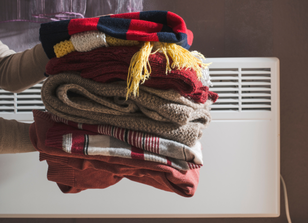 Someone holding a stacked pile on blankets.
