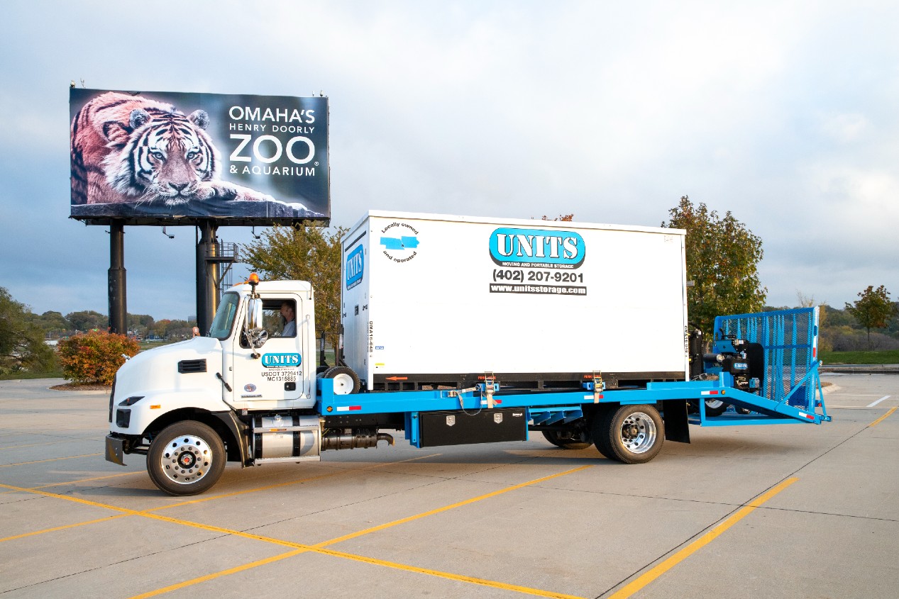 Portable Storage Units of Omaha & Lincoln truck parked in a parking lot outside of a zoo