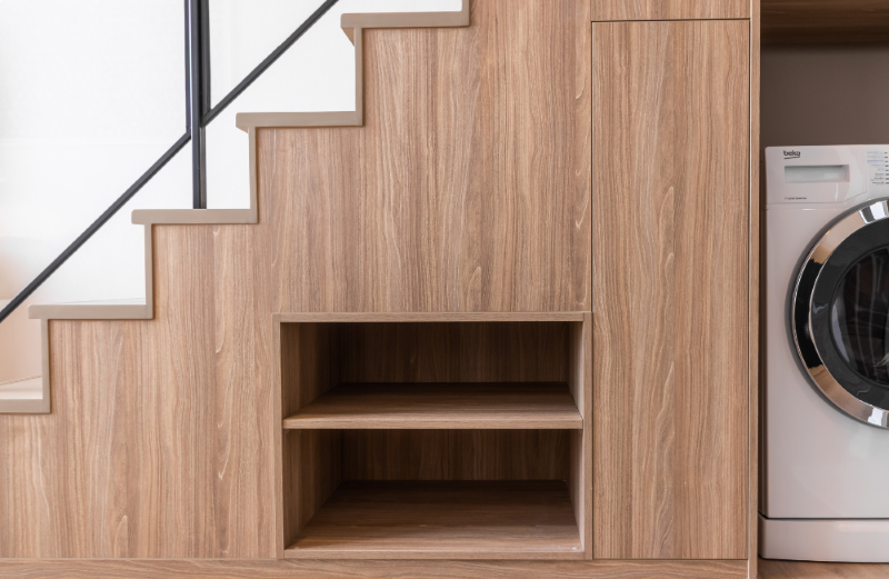Wooden shelf hidden in a staircase.